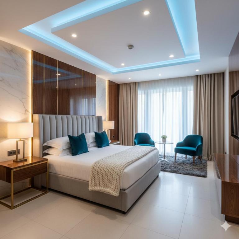 a bedroom with a large bed with blue pillows at Hotel King Plaza in Nikurān