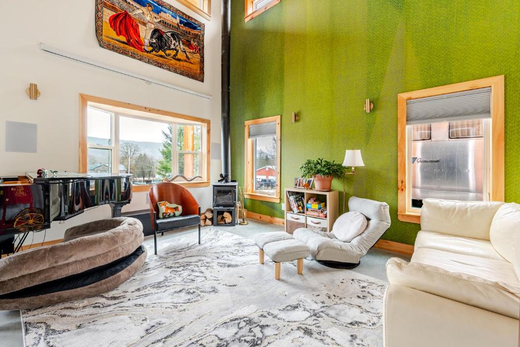 a living room with green walls and white furniture at Modern Cabin near Watkins Glen in Alpine