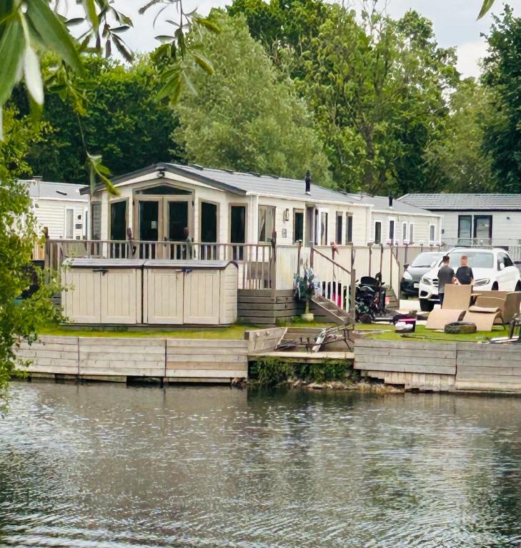 a house on a dock next to a body of water at Sunset retreat in Crowle