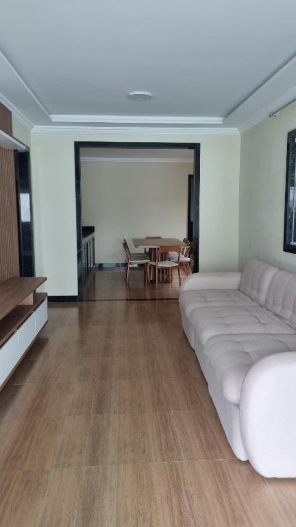 a living room with a bed and a table at Casa dos Vieira in Marataizes