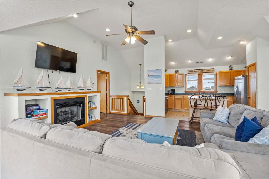 a living room with two couches and a fireplace at Sea Spray in Waves