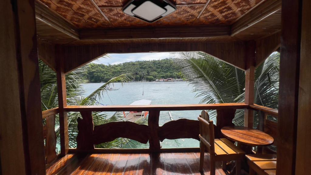 a view of the water from a room with a window at Aviniel Cottage in Puerto Galera