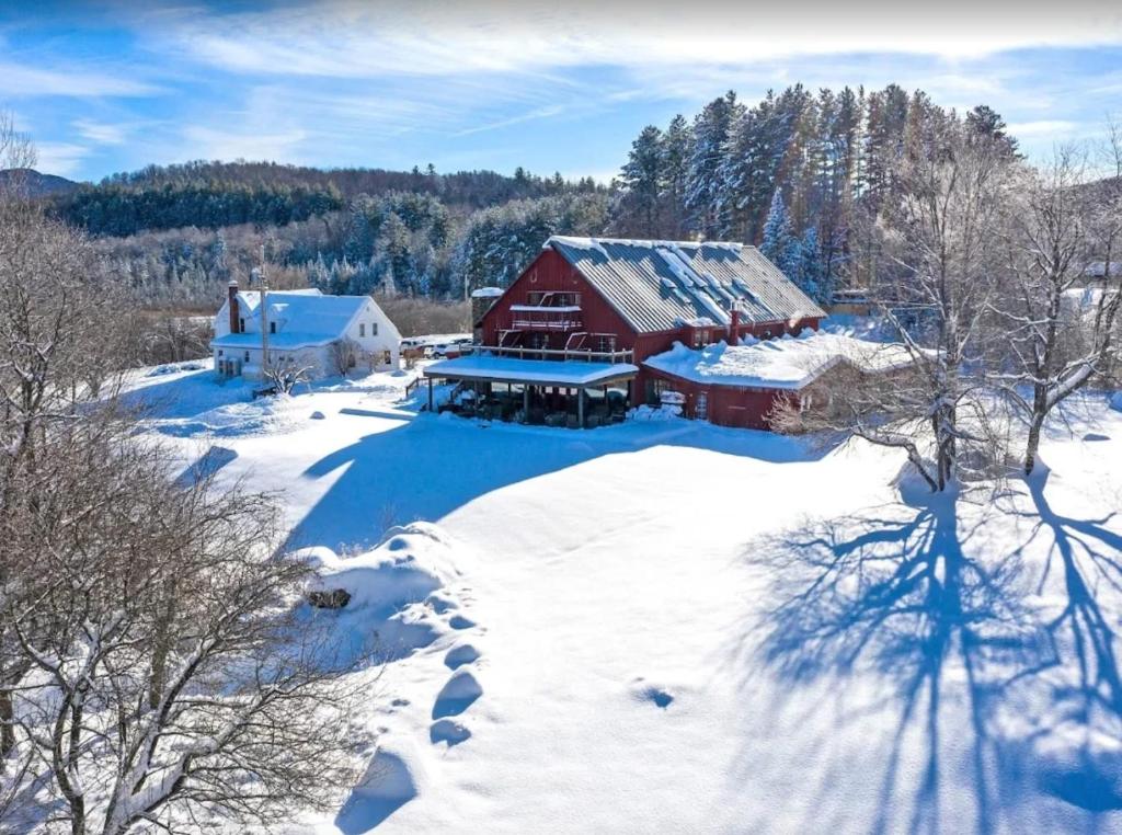 an aerial view of a red barn in the snow at Mountain Meadows Lodge in Killington