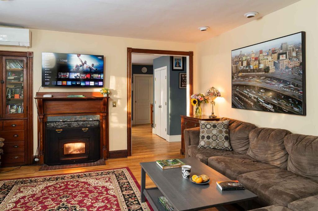 a living room with a couch and a fireplace at Forest City Oasis and Spa in South Portland