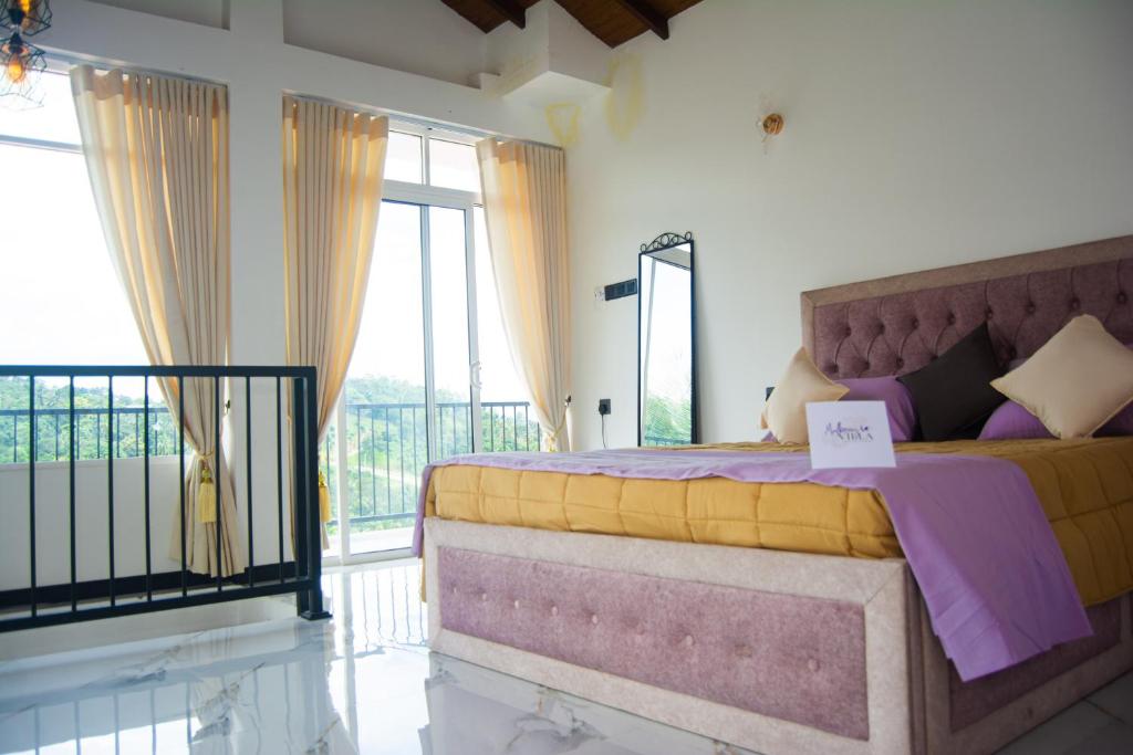 a bedroom with a large bed and a balcony at Mulberry villa in Kandy
