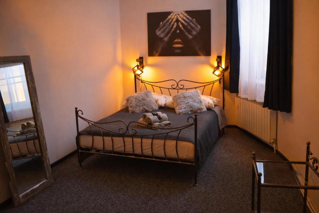 a bedroom with a bed with two stuffed animals on it at Apartament X in Przemyśl