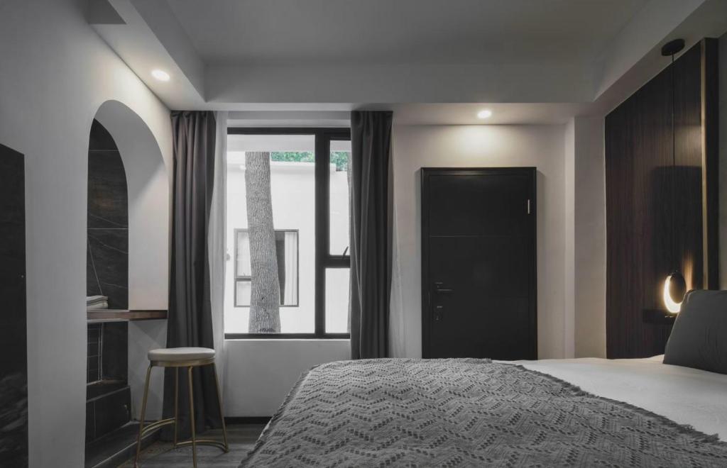 a bedroom with a bed and a window at My loft ChengDu in Chengdu