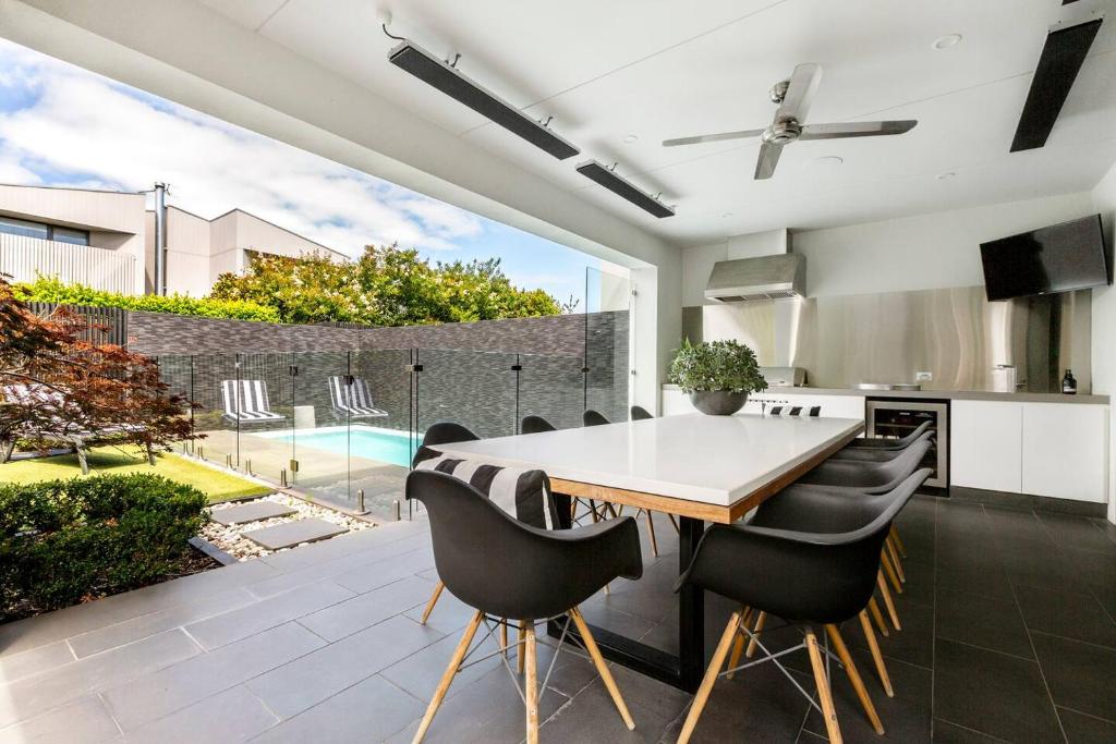 a kitchen and dining room with a table and chairs at The Pool Pavilion - Where City meets Beach in Melbourne