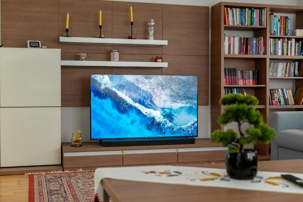 a living room with a large flat screen tv at Petra's Skyline in Suceava