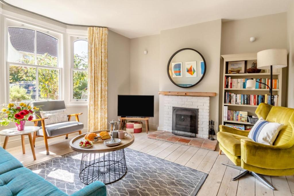 a living room with a blue couch and a fireplace at 4 Bed in Walberswick oc-hwfern in Walberswick