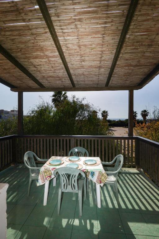 a table and chairs sitting on a deck at Ocra Fronte Mare in Torre Mozza