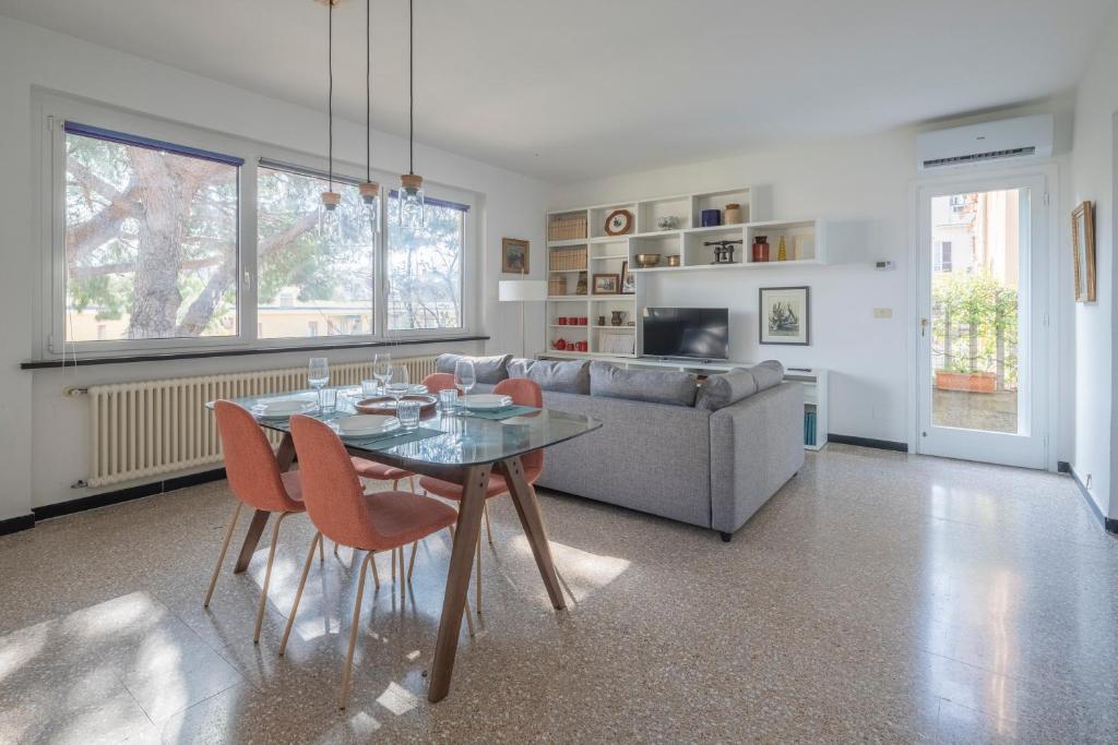 a living room with a glass table and a couch at Torre Dell'Amore, Genova, Seaview in Genoa