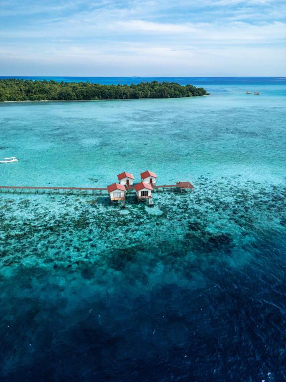 an aerial view of a house in the water at Coco Seaweed Resort in Semporna