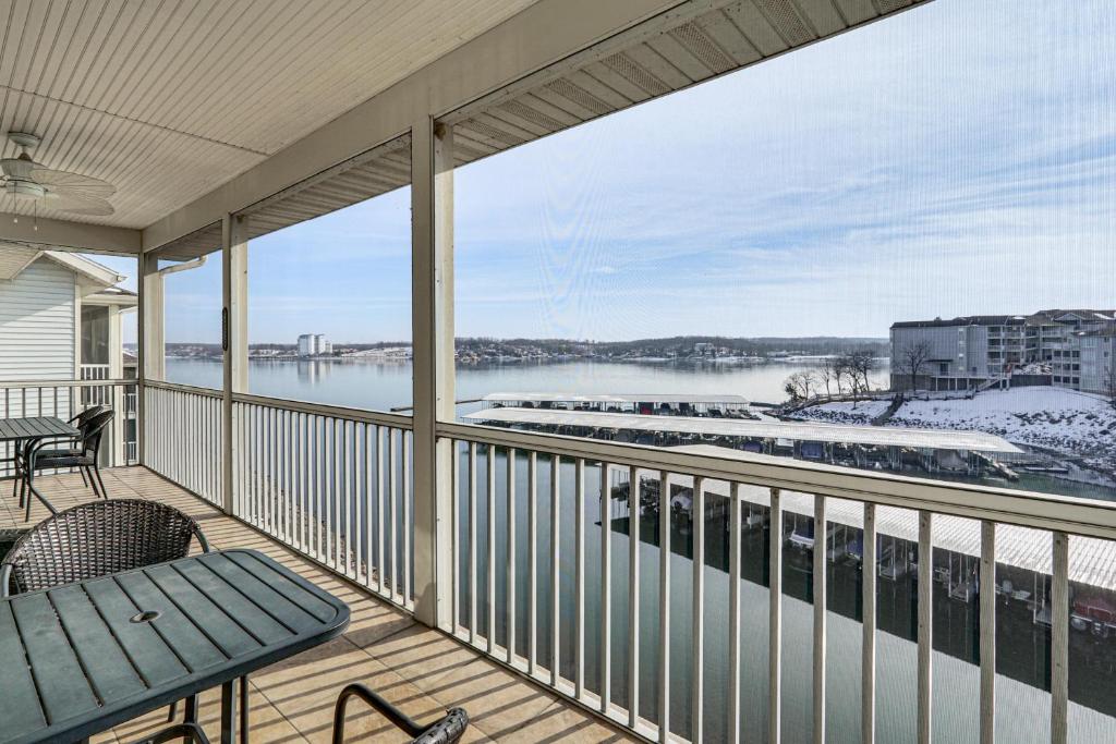 a balcony with a view of a marina at Lake View + Pool Access: Waterfront Ozark Escape! in Four Seasons