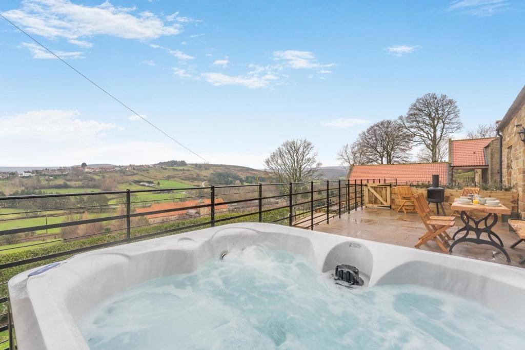 a bath tub filled with water on top of a balcony at 2 Bed in Castleton oc-f34013 in Castleton