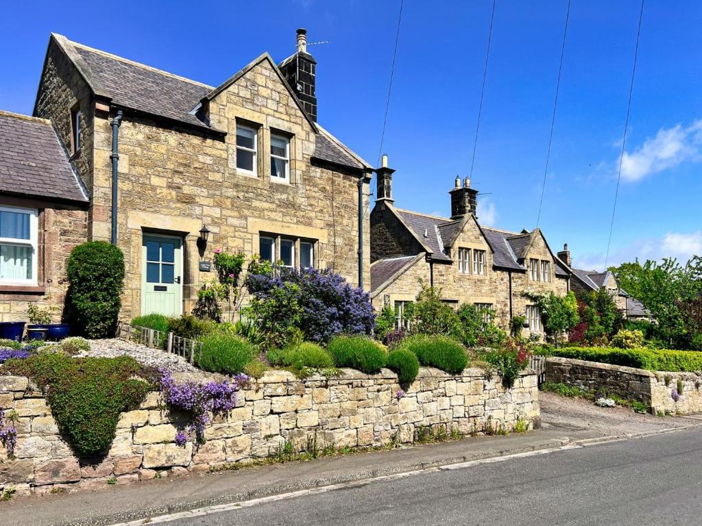 a row of houses with a stone wall at 2 Bed in Chatton oc-r27205 in Chatton