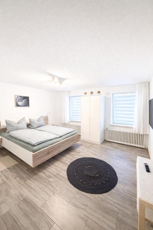 a bedroom with a bed and a rug at Ferienwohnung AyNa 4, direkt an der Schweizer Grenze in Bad Säckingen