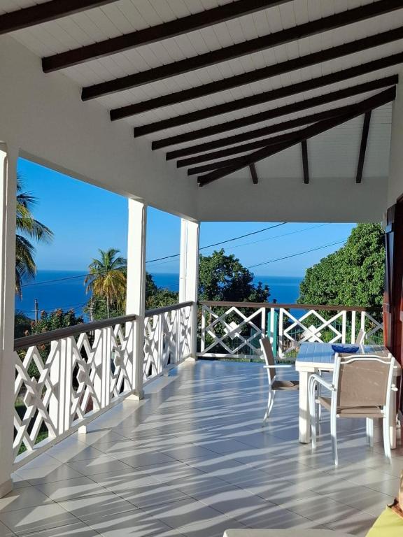 a balcony with a view of the ocean at Chrysalide in Baillif
