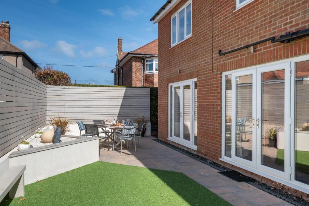 a garden with a patio with a table and chairs at 5 Bed in Seahouses oc-nb621 in Seahouses