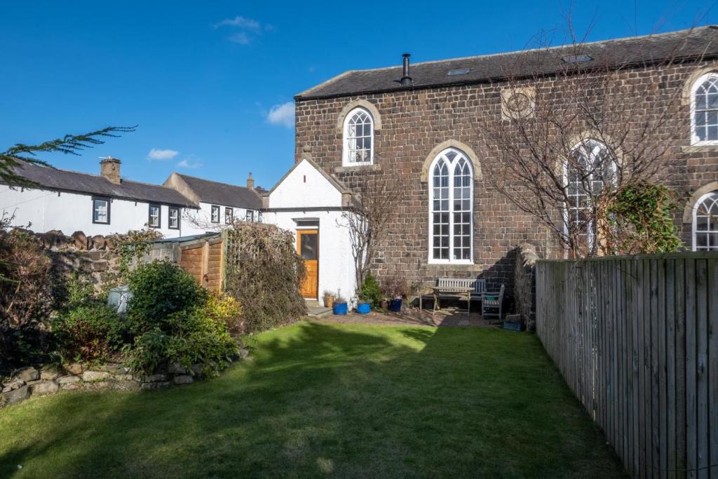a large brick house with a grass yard at 2 Bed in Embleton oc-nb1960 in Embleton