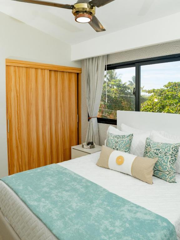 a bedroom with a bed and a large window at Ocean Winds Hotel in San Felipe de Puerto Plata