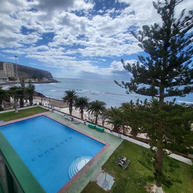 a swimming pool with a view of the ocean at Ocean View 3 in Los Cristianos
