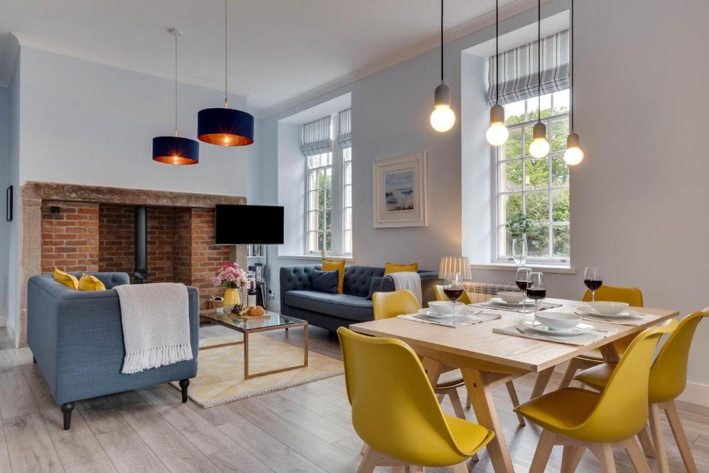 a dining room and living room with a table and chairs at 2 Bed in Beadnell oc-gd1889 in Beadnell
