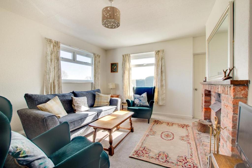 a living room with a couch and a fireplace at 2 Bed in Berwick-upon-Tweed oc-gd1871 in Ancroft