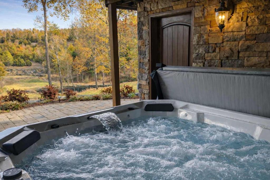 a jacuzzi tub with water coming out of it at The Bunkhouse at Rock Canyon in Branson