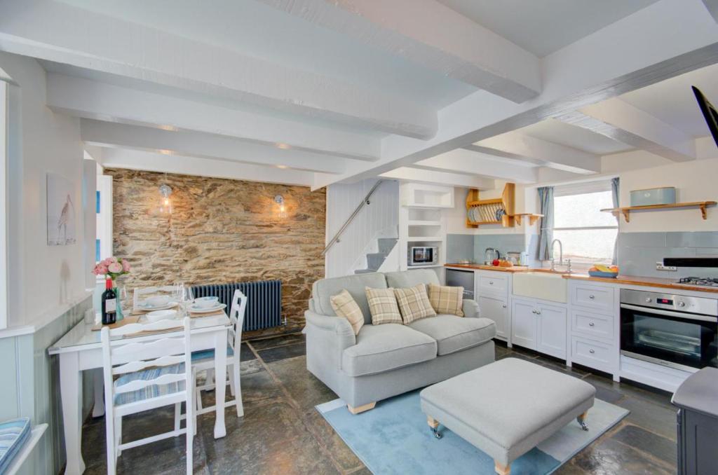 a kitchen and living room with a couch and a table at 2 Bed in West Looe oc-l30054 in Looe