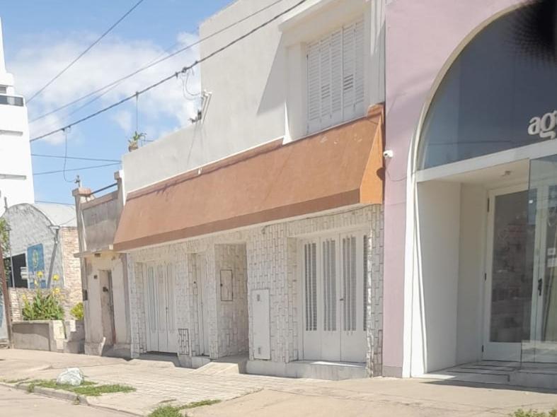 a building with doors on the side of a street at Vm casa in Villa María