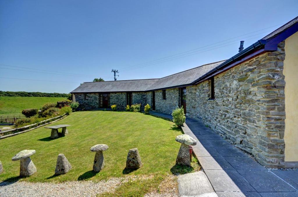 a stone church with stone statues in the yard at 3 Bed in St Columb oc-trembl in Saint Mawgan