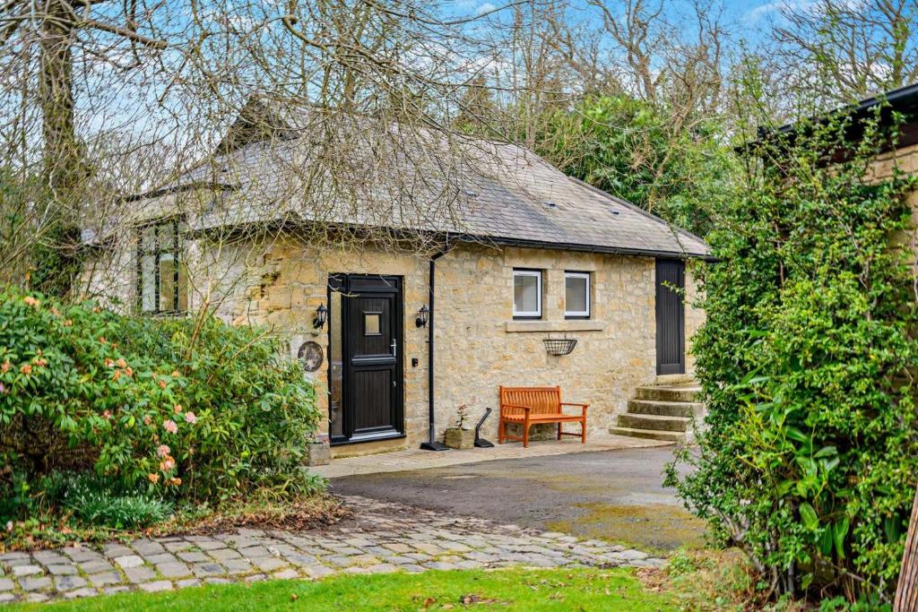a small brick house with a bench in front of it at 2 Bed in Shotley Bridge oc-h29037 in Shotley Bridge