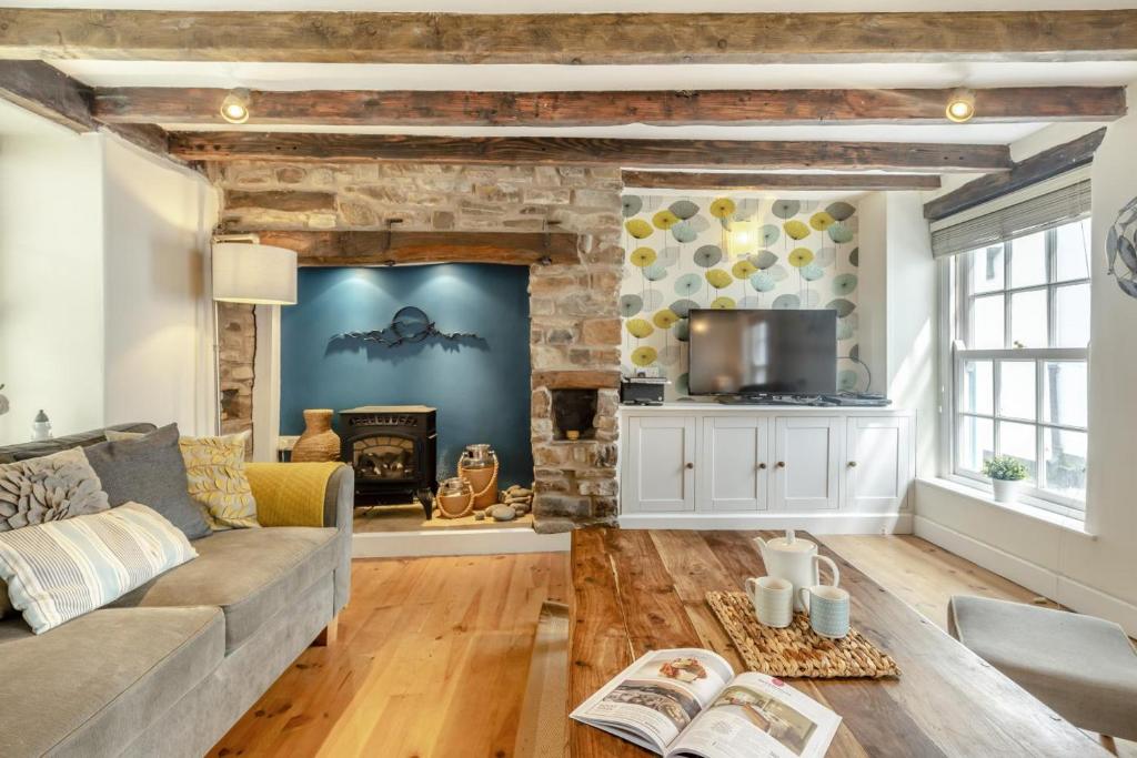 a living room with a couch and a fireplace at 3 Bed in Appledore oc-f29064 in Appledore