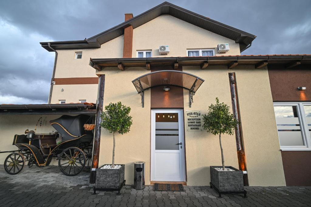 a horse drawn carriage parked outside of a building at Five stars in Dubrava