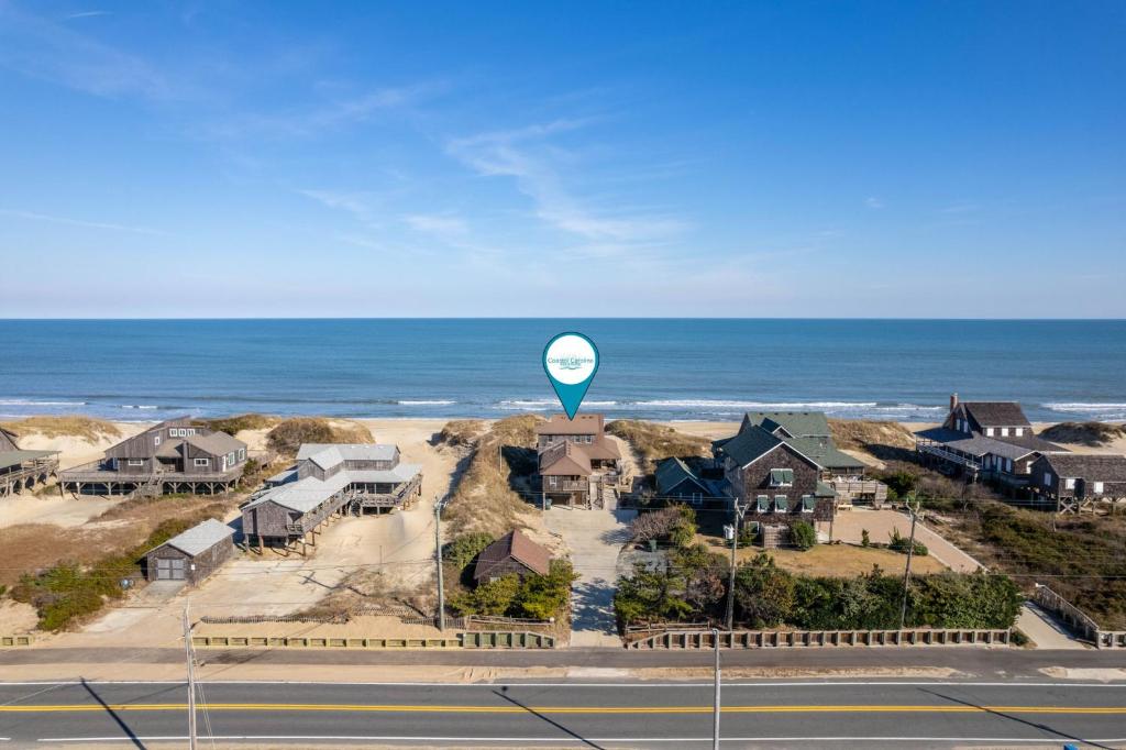a blue hot air balloon in front of houses and the ocean at NH330 It's Beach Time in Nags Head