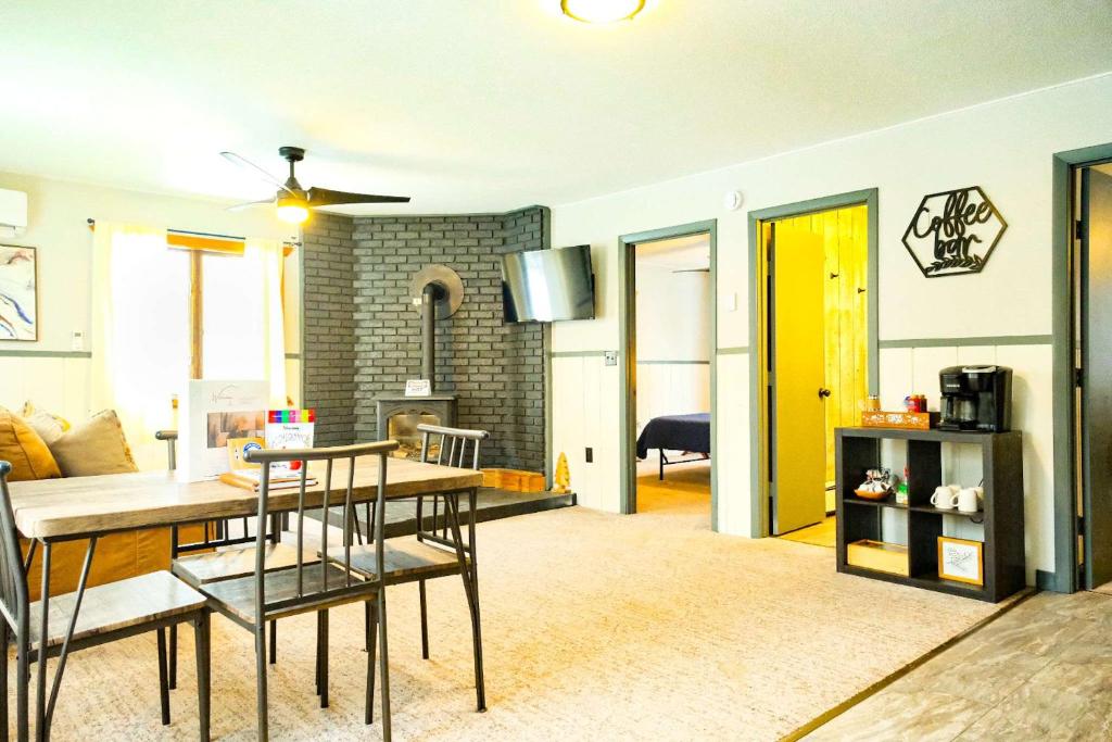 a living room with a kitchen and a dining room at Charming Ski Chalet at Powderhorn Mountain in Bessemer
