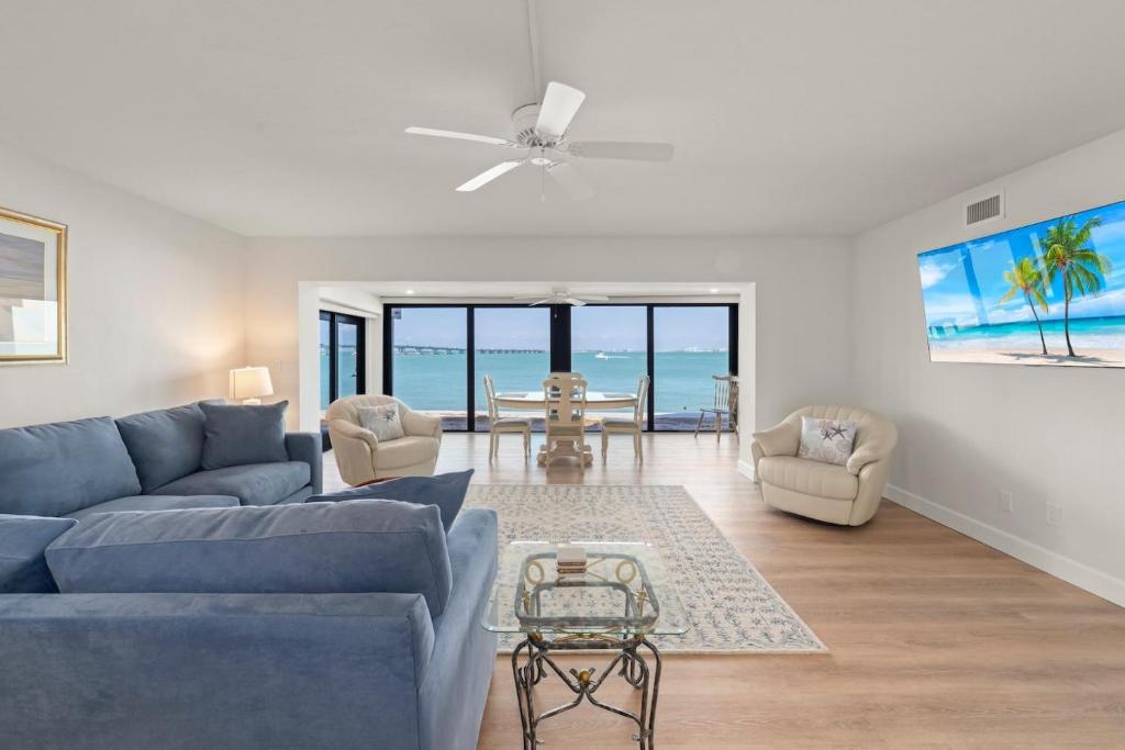a living room with a blue couch and chairs at Mariner Pointe 941 in Sanibel