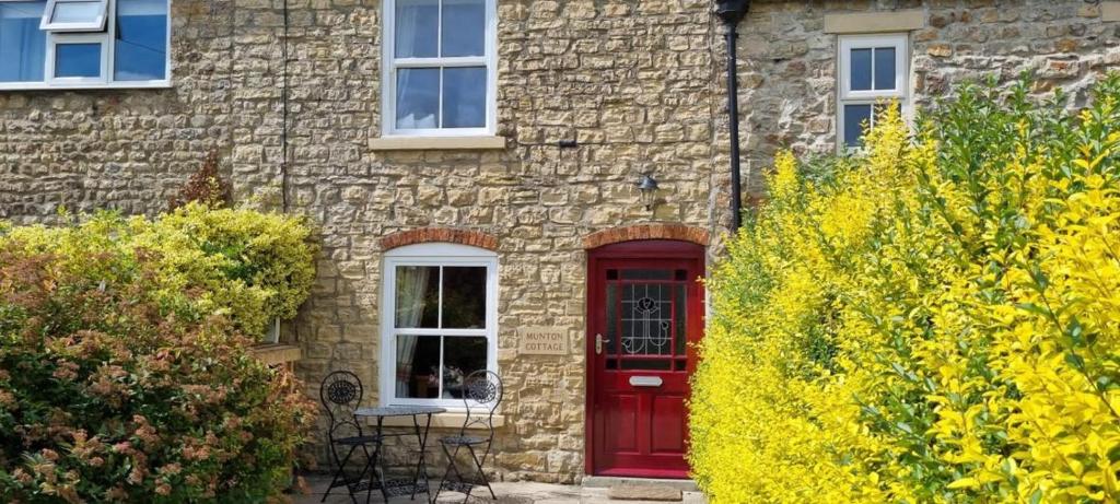 a brick house with a red door and windows at 1 Bed in Crakehall oc-ds955 in Crakehall
