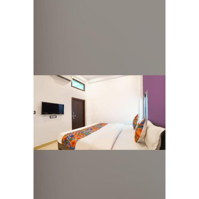 a hotel room with a bed and a tv at Awadh Ram Hotel in Ayodhya