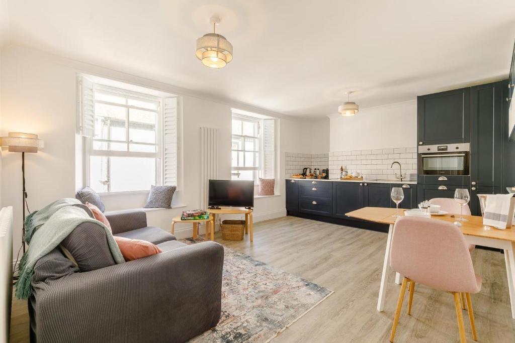 a living room with a couch and a kitchen at 1 Bed in Looe oc-l30038 in Looe