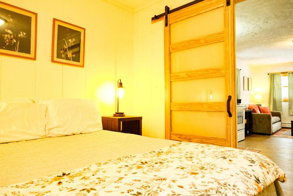a bedroom with a bed and a open door at Snowbound Bliss at Powderhorn Mountain in Bessemer
