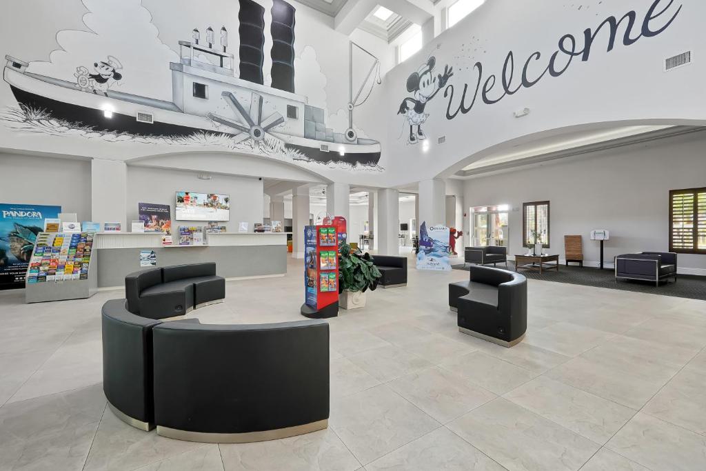 a lobby with chairs and a welcome sign in a store at Disney 1st floorEpicFREE ShuttlePARKINGNO FEES in Orlando