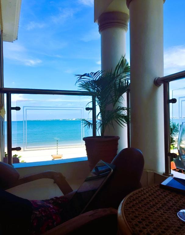 a living room with a view of the ocean at Oceanfront Executive Serviced Apartment Mbezi Beach in Dar es Salaam