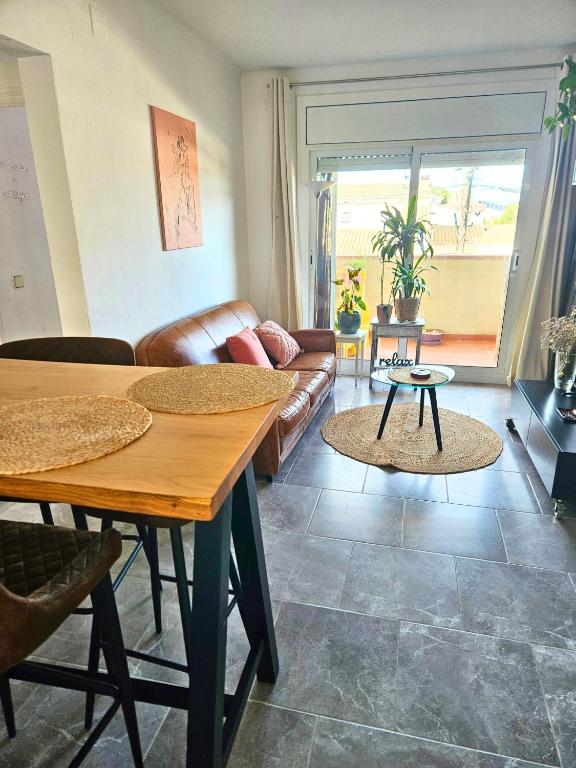 a living room with a couch and a table at Digital Nomad Apartment in L'Escala
