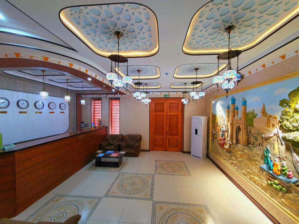 a lobby with a large screen in a building at DREAM PLAZA HOTEL for your convenience in Bukhara