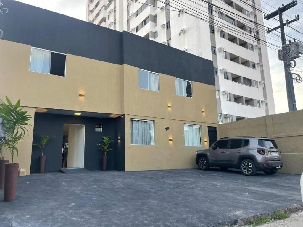 a car parked in a parking lot in front of a building at Pousada Terraço das Aguas in Maceió