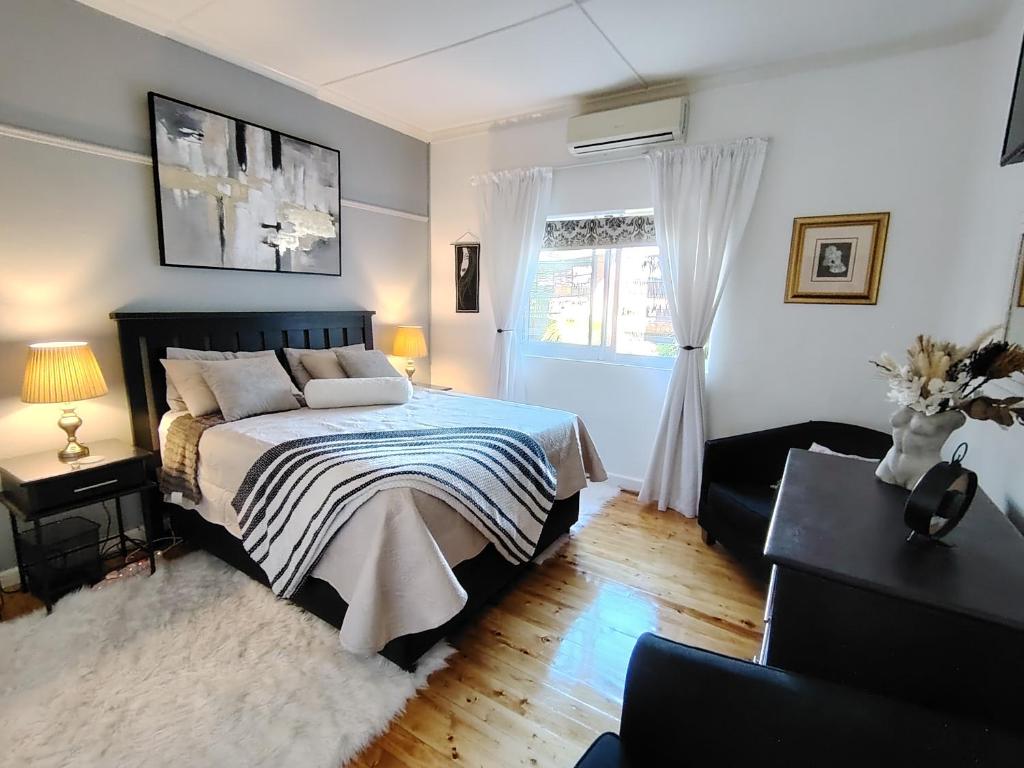 a bedroom with a bed and a window at The Urban Oasis 4 guests Port Elizabeth Gqeberha in Gqeberha