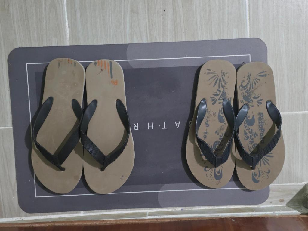 a blue picture of four pairs of shoes at Ibus Nawi homes in Lodwar