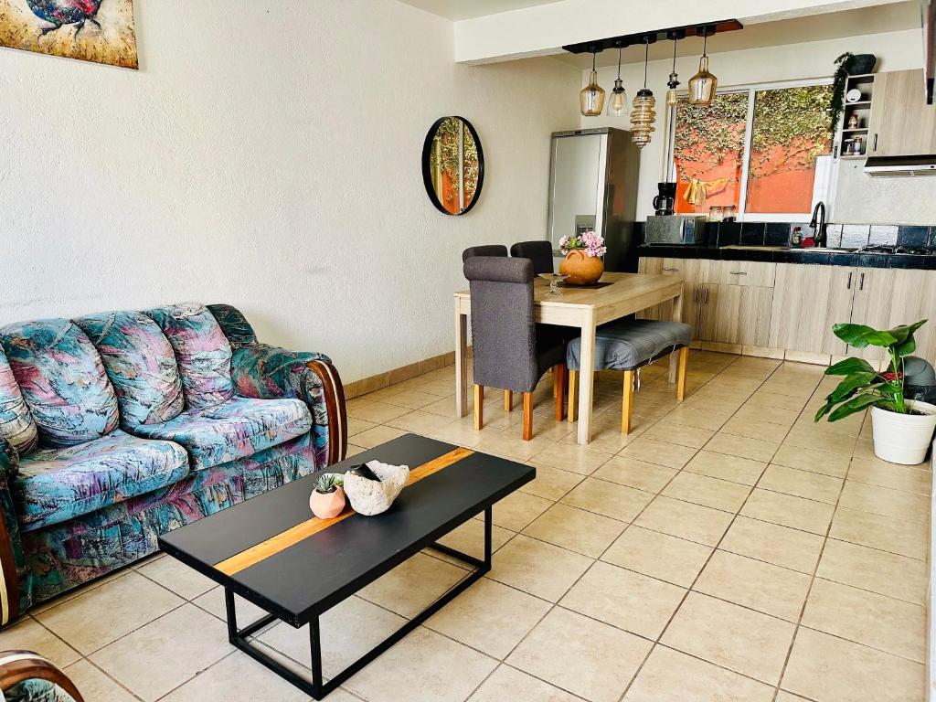 a living room with a couch and a table at Casita Iluminada in Oaxaca City